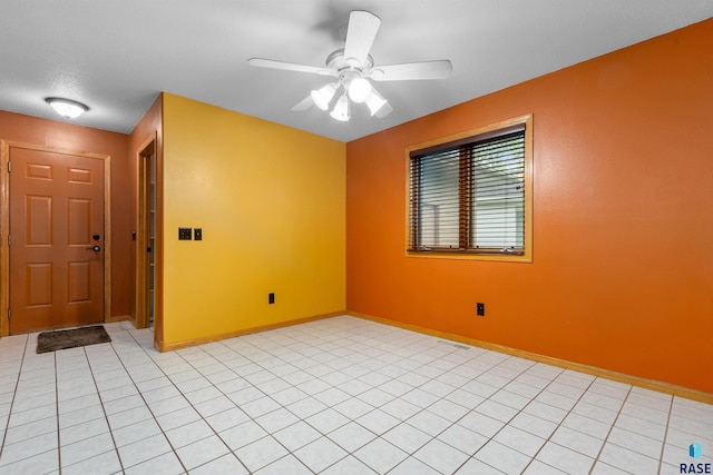 6700 W Snowberry Cir, Sioux Falls, SD 57106 - empty room featuring light tile patterned floors, baseboards, and a ceiling fan