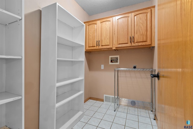6700 W Snowberry Cir, Sioux Falls, SD 57106 - laundry area featuring hookup for an electric dryer, hookup for a washing machine, light tile patterned floors, cabinet space, and baseboards