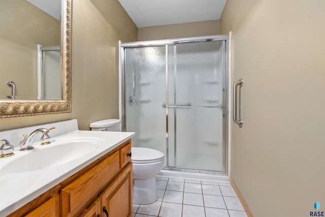 6700 W Snowberry Cir, Sioux Falls, SD 57106 - bathroom featuring toilet, a stall shower, vanity, and tile patterned flooring