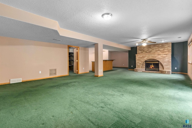 6700 W Snowberry Cir, Sioux Falls, SD 57106 - unfurnished living room featuring a brick fireplace, carpet floors, a ceiling fan, baseboards, and a textured ceiling