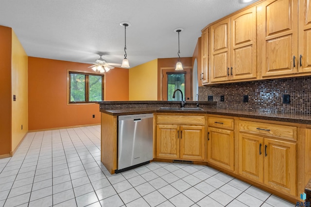 6700 W Snowberry Cir, Sioux Falls, SD 57106 - kitchen with dishwasher, a sink, a ceiling fan, a peninsula, and backsplash