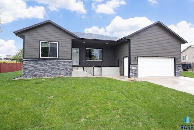208 W Veterans Dr, Luverne, MN 56156 - view of front facade featuring stone siding, concrete driveway, an attached garage, and covered porch
