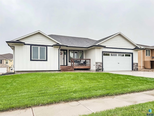 712 Trojan Ave, Hartford, SD 57033 - ranch-style home with covered porch, board and batten siding, a garage, a front yard, and driveway