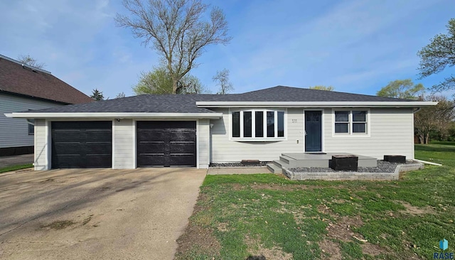 511 N 3rd St, Emery, SD 57332 - single story home with driveway, an attached garage, a front yard, and a shingled roof