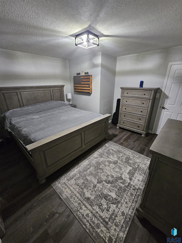 511 N 3rd St, Emery, SD 57332 - bedroom featuring dark wood finished floors and a textured ceiling
