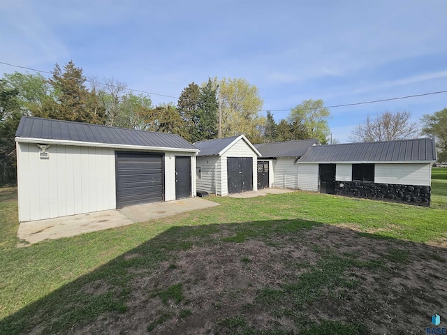 511 N 3rd St, Emery, SD 57332 - view of green lawn with an outdoor structure and a garage