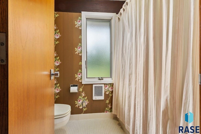 1003 N Pleasantview Pl, Sioux Falls, SD 57110 - bathroom featuring toilet, tile patterned flooring, heating unit, and baseboards