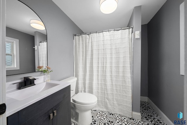 209 E Elm St, Harrisburg, SD 57032 - full bathroom featuring toilet, vanity, tile patterned floors, and a shower with curtain