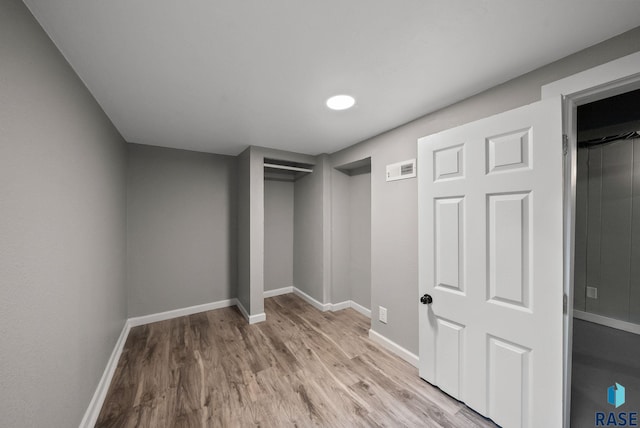 209 E Elm St, Harrisburg, SD 57032 - unfurnished bedroom with light wood-style floors, baseboards, and a closet