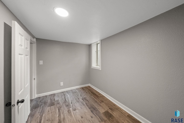 209 E Elm St, Harrisburg, SD 57032 - spare room featuring wood finished floors and baseboards