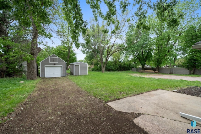 209 E Elm St, Harrisburg, SD 57032 - view of yard featuring a garage and dirt driveway