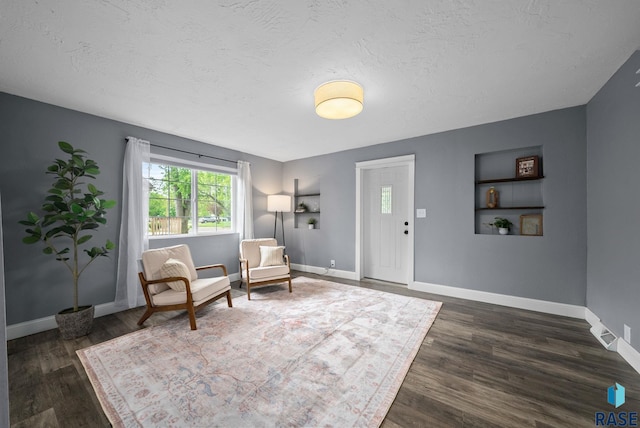 209 E Elm St, Harrisburg, SD 57032 - sitting room featuring baseboards, dark wood finished floors, and a textured ceiling