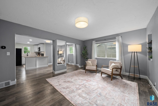 209 E Elm St, Harrisburg, SD 57032 - sitting room featuring dark wood-style flooring and baseboards