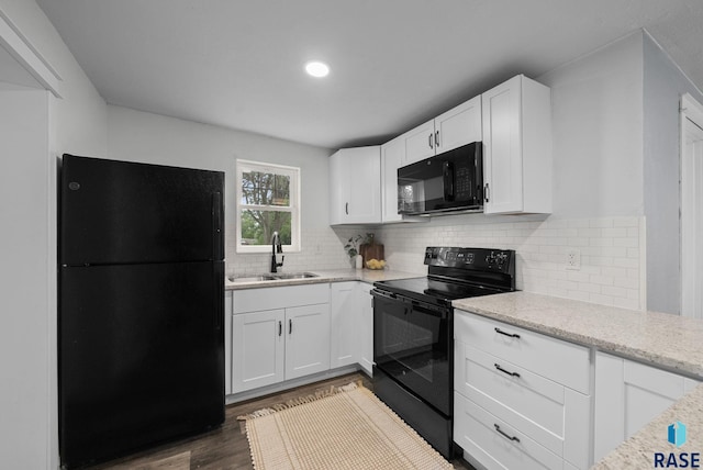 209 E Elm St, Harrisburg, SD 57032 - kitchen with black appliances, a sink, wood finished floors, white cabinetry, and tasteful backsplash