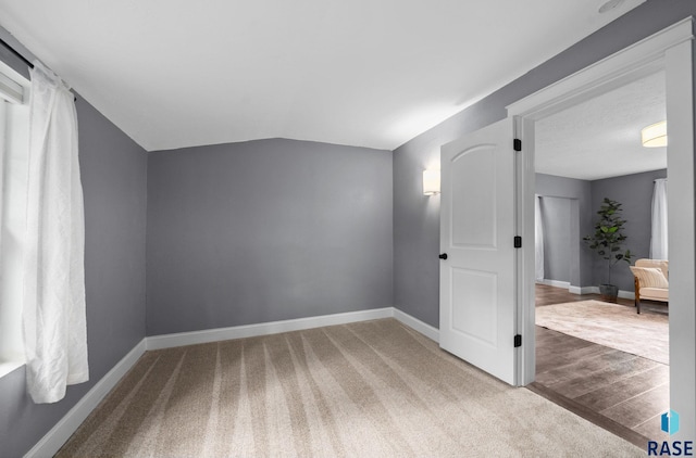 209 E Elm St, Harrisburg, SD 57032 - additional living space featuring baseboards, carpet floors, and vaulted ceiling