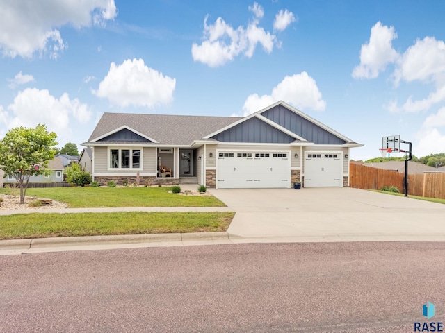 1302 Ripple Creek Rd, Dell Rapids, SD 57022 - craftsman inspired home featuring board and batten siding, an attached garage, concrete driveway, and stone siding