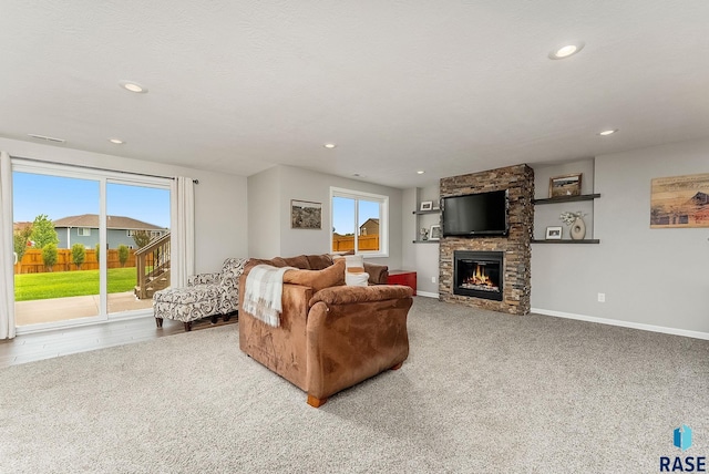 1302 Ripple Creek Rd, Dell Rapids, SD 57022 - living room featuring carpet floors, a stone fireplace, baseboards, and recessed lighting