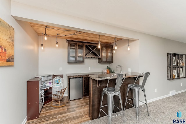 1302 Ripple Creek Rd, Dell Rapids, SD 57022 - indoor wet bar with fridge, wood ceiling, decorative light fixtures, baseboards, and wood finished floors