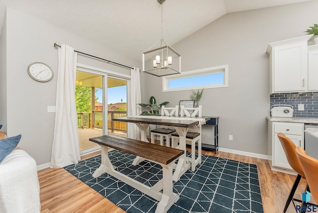 1302 Ripple Creek Rd, Dell Rapids, SD 57022 - dining space featuring lofted ceiling, a chandelier, light wood-type flooring, and baseboards