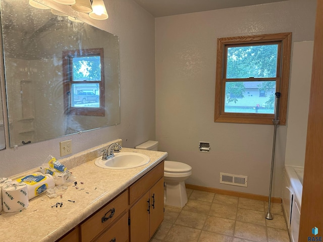 800 N Poplar St, Bridgewater, SD 57319 - bathroom featuring toilet, vanity, baseboards, and a bath