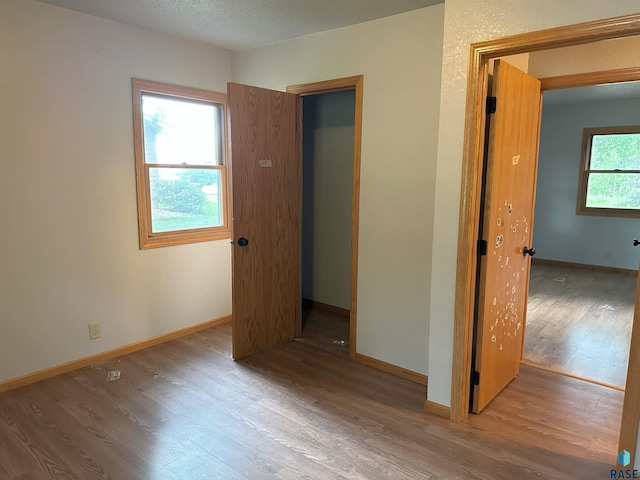 800 N Poplar St, Bridgewater, SD 57319 - unfurnished bedroom featuring wood finished floors and baseboards