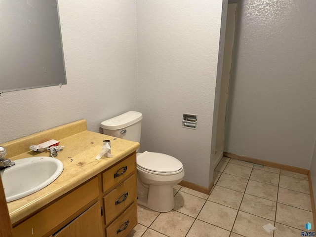 800 N Poplar St, Bridgewater, SD 57319 - bathroom featuring toilet, vanity, tile patterned flooring, and baseboards