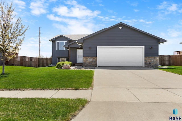 7305 W Jacob Cir, Sioux Falls, SD 57106 - view of front facade featuring an attached garage, concrete driveway, and stone siding