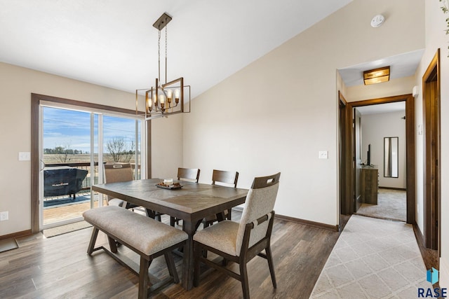 7305 W Jacob Cir, Sioux Falls, SD 57106 - dining area with wood finished floors, a chandelier, and baseboards