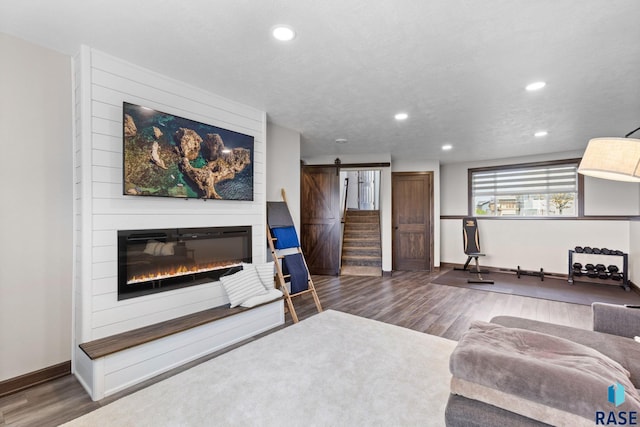 7305 W Jacob Cir, Sioux Falls, SD 57106 - living area with a barn door, wood finished floors, baseboards, recessed lighting, and a large fireplace