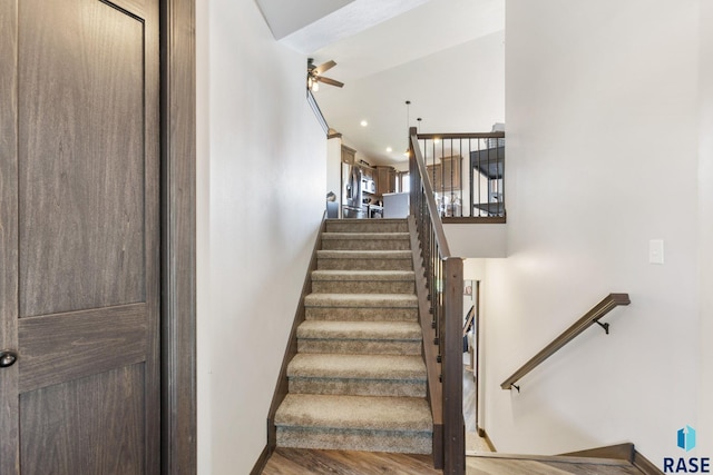 7305 W Jacob Cir, Sioux Falls, SD 57106 - staircase featuring a ceiling fan, wood finished floors, and baseboards