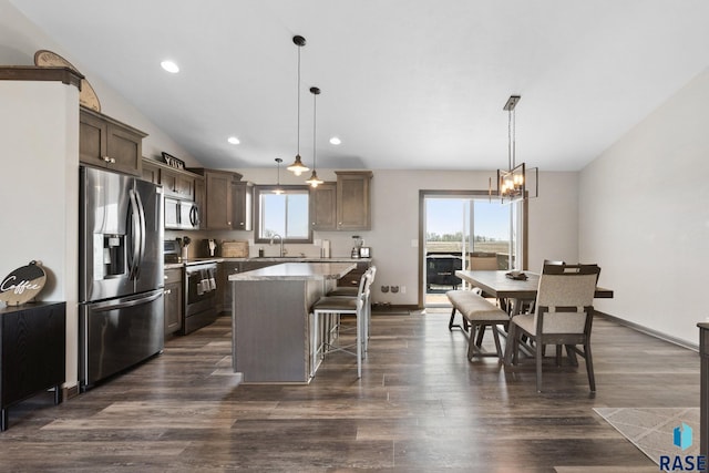 7305 W Jacob Cir, Sioux Falls, SD 57106 - kitchen with stainless steel appliances, healthy amount of natural light, a kitchen island, a kitchen bar, and recessed lighting