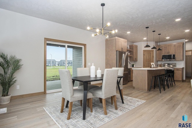 501 S Huckleberry Trl, Harrisburg, SD 57032 - dining space with a chandelier, light wood finished floors, recessed lighting, and baseboards