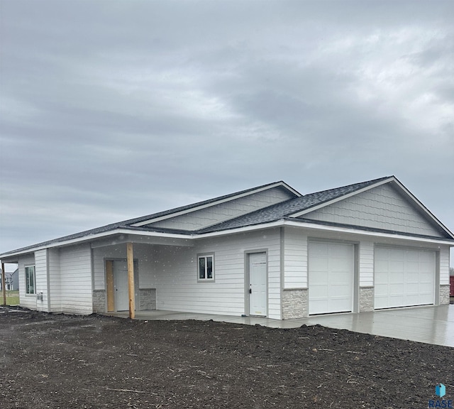 507 S Huckleberry Trl, Harrisburg, SD 57032 - view of front facade with stone siding, concrete driveway, and an attached garage