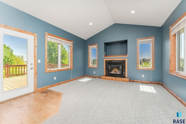 1817 W Ashton Trl, Brandon, SD 57005 - unfurnished living room with vaulted ceiling, baseboards, a premium fireplace, and carpet