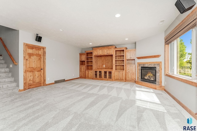 1817 W Ashton Trl, Brandon, SD 57005 - unfurnished living room featuring light carpet, a fireplace, stairs, baseboards, and recessed lighting