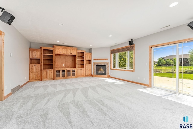 1817 W Ashton Trl, Brandon, SD 57005 - unfurnished living room featuring baseboards, light carpet, recessed lighting, and a glass covered fireplace