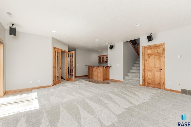 1817 W Ashton Trl, Brandon, SD 57005 - unfurnished living room featuring recessed lighting, stairs, baseboards, bar, and light colored carpet