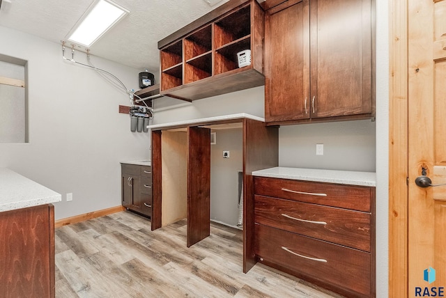 1817 W Ashton Trl, Brandon, SD 57005 - kitchen with light wood-style flooring, light stone countertops, open shelves, and baseboards
