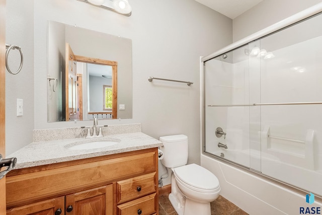1817 W Ashton Trl, Brandon, SD 57005 - full bath with toilet, vanity, shower / bath combination with glass door, tile patterned flooring, and baseboards