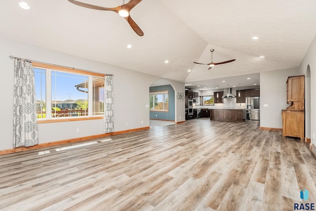 1817 W Ashton Trl, Brandon, SD 57005 - unfurnished living room with a ceiling fan, arched walkways, baseboards, light wood-style floors, and recessed lighting