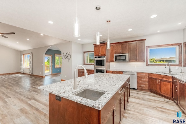 1817 W Ashton Trl, Brandon, SD 57005 - kitchen featuring appliances with stainless steel finishes, a sink, an island with sink, decorative backsplash, and recessed lighting