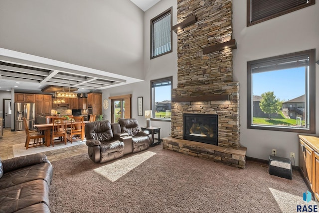 1301 S Hyannis Port Ln, Sioux Falls, SD 57106 - living area featuring a fireplace, coffered ceiling, light carpet, beam ceiling, and a high ceiling