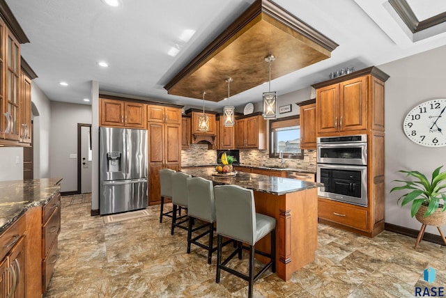 1301 S Hyannis Port Ln, Sioux Falls, SD 57106 - kitchen with stainless steel appliances, a sink, brown cabinets, backsplash, and recessed lighting