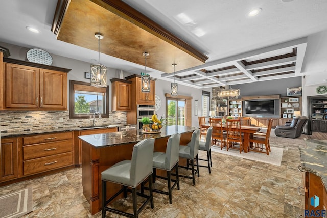 1301 S Hyannis Port Ln, Sioux Falls, SD 57106 - kitchen featuring a sink, brown cabinetry, decorative backsplash, healthy amount of natural light, and coffered ceiling
