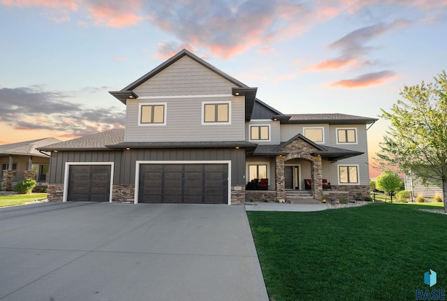 1301 S Hyannis Port Ln, Sioux Falls, SD 57106 - view of front of property with board and batten siding, stone siding, concrete driveway, a lawn, and a garage