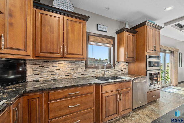 1301 S Hyannis Port Ln, Sioux Falls, SD 57106 - kitchen featuring appliances with stainless steel finishes, a sink, brown cabinetry, backsplash, and recessed lighting