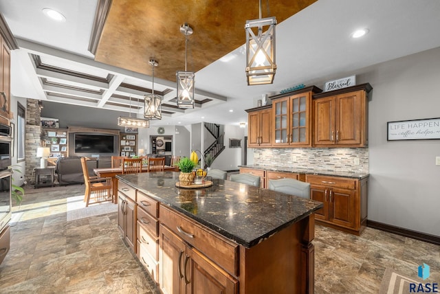1301 S Hyannis Port Ln, Sioux Falls, SD 57106 - kitchen with brown cabinets, open floor plan, coffered ceiling, backsplash, and a kitchen island