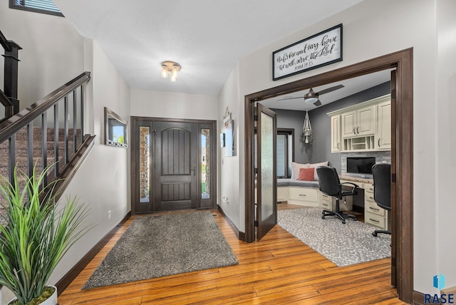 1301 S Hyannis Port Ln, Sioux Falls, SD 57106 - foyer with wood finished floors, stairs, a ceiling fan, and healthy amount of natural light