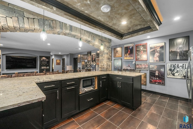 1301 S Hyannis Port Ln, Sioux Falls, SD 57106 - bar area featuring built in microwave, pendant lighting, a tray ceiling, dark tile patterned flooring, and recessed lighting