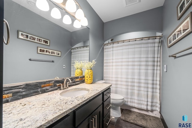 1301 S Hyannis Port Ln, Sioux Falls, SD 57106 - bathroom featuring vanity, toilet, and curtained shower